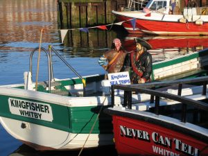 Carved images of pirates on a boat in Whitby, Yorkshire, UK harbor