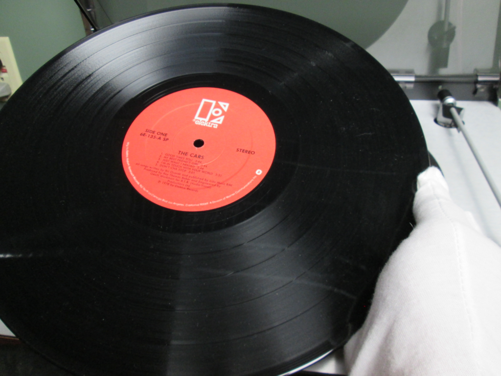 Handling an LP with white cotton gloves